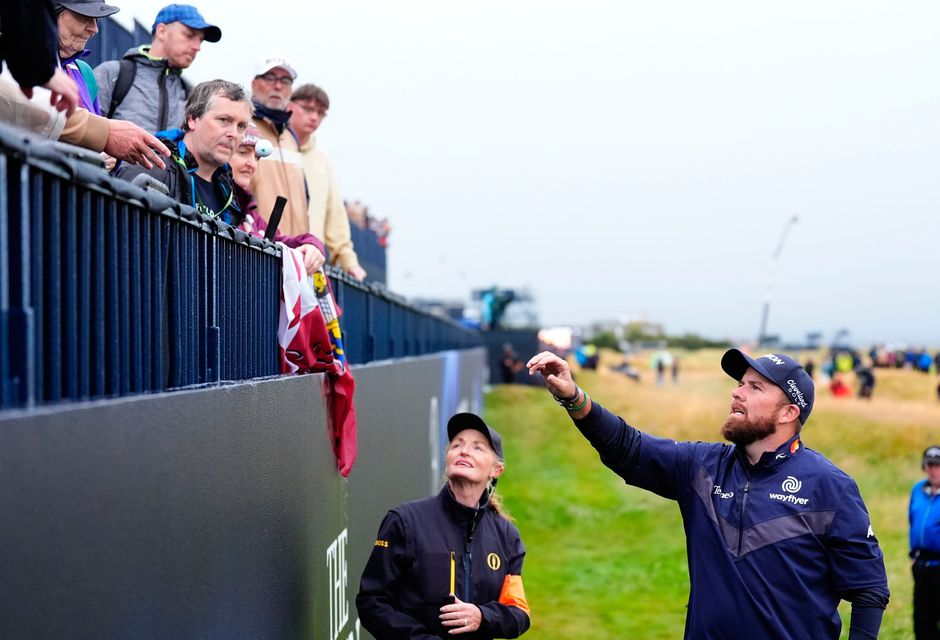 Ireland's Shane Lowry collects his ball from the stand on the 18th