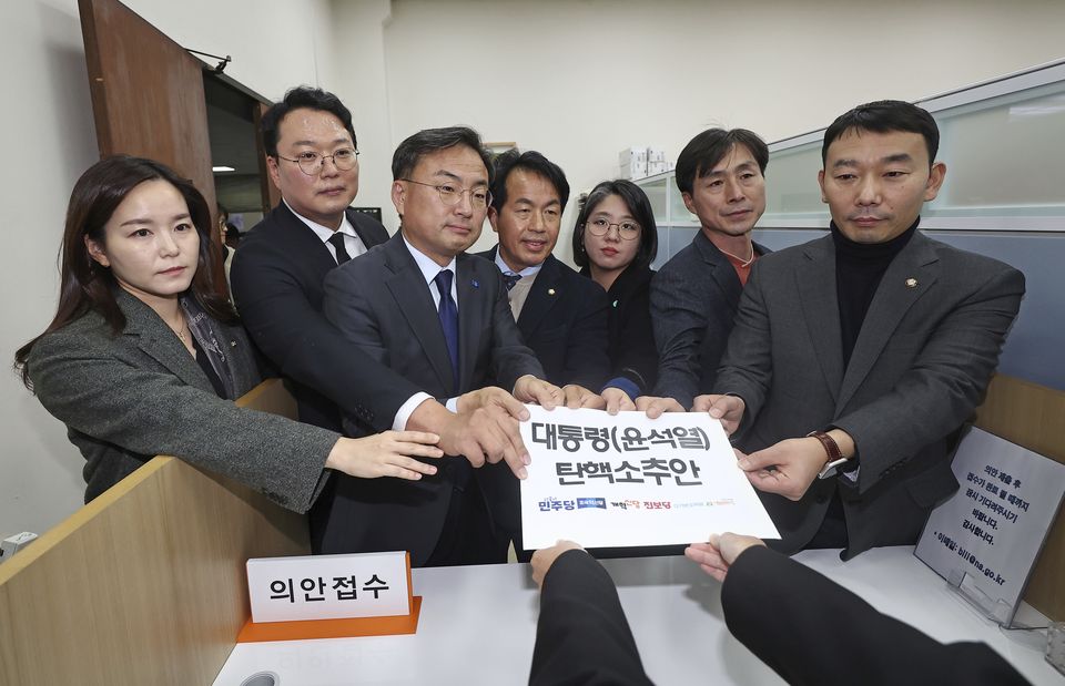 Members of the Democratic Party joined other minor opposition parties in submitting a bill to impeach President Yoon Suk Yeol (Ryu Hyung-seok/Yonhap via AP)