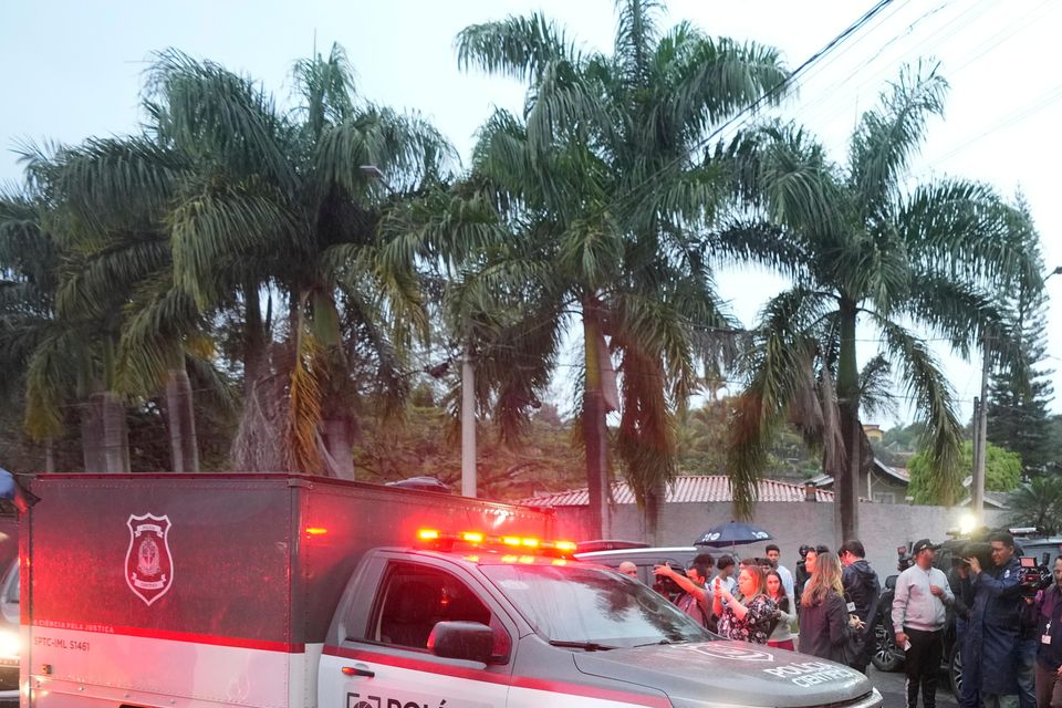 Police vehicles arrive at the gated community where a plane crashed in Vinhedo, Sao Paulo state, Brazil (Andre Penner/AP)