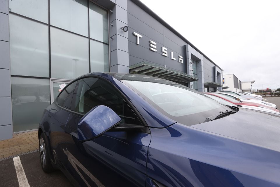 Cars on the forecourt of the Tesla dealership on the Boucher Road in Belfast (Liam McBurney/PA)