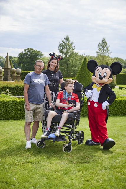 Barney and his parents meeting Mickey Mouse (StillMoving/Disney/PA)