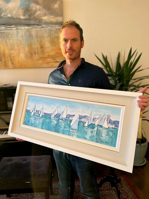 Artist Adrian Margey with a seascape