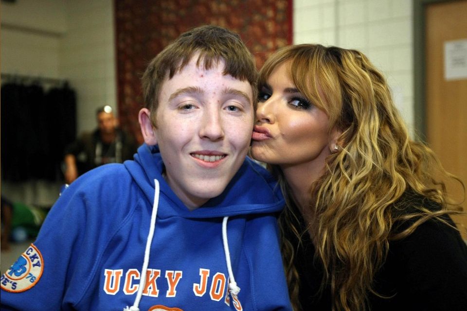 The envy of his mates: Conor Smyth (16) gets a kiss from Nadine Coyle backstage at the Girls Aloud concert