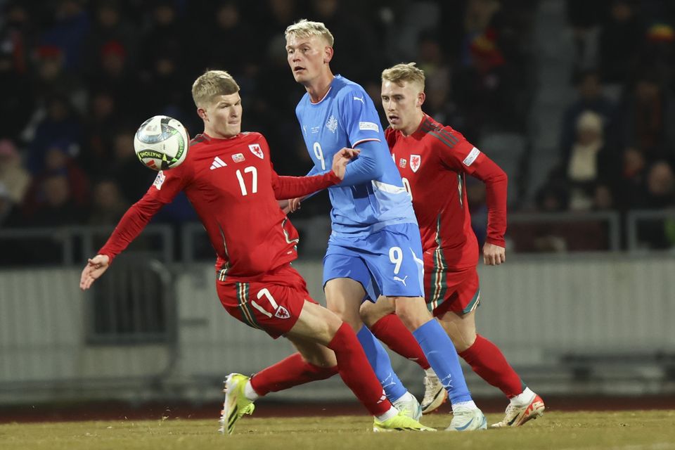 Wales midfielder Jordan James, left, challenges Iceland’s Orri Óskarsson in their 2-2 Nations League draw in Reykjavik (Arni Torfason/AP)