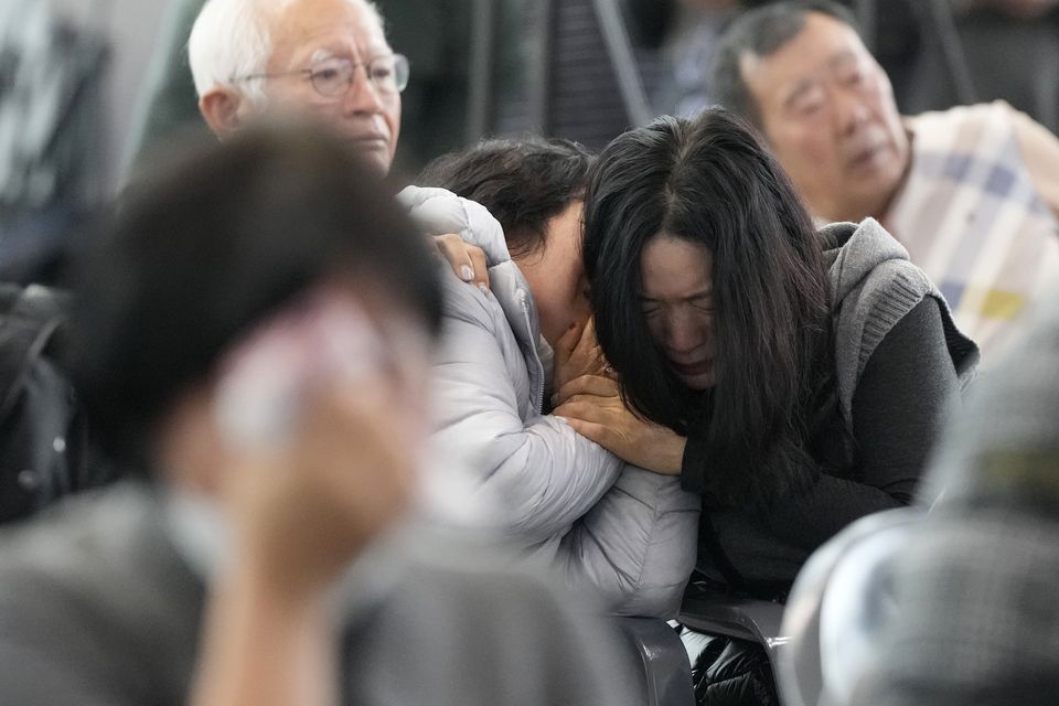 Grieving relatives gather at Muan International Airport in South Korea after Sunday’s crash (Ahn Young-joon/AP)