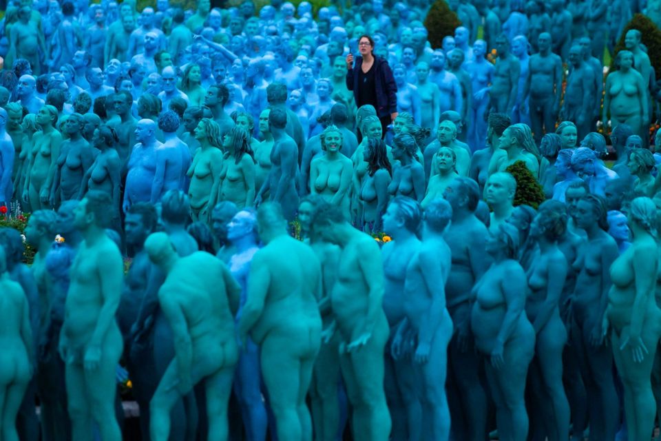 Naked volunteers, painted in blue to reflect the colours found in Marine paintings in Hull's Ferens Art Gallery, prepare to participate in US artist, Spencer Tunick's "Sea of Hull" installation in Queen's Gardens in Kingston upon Hull on July 9, 2016. AFP/Getty Images