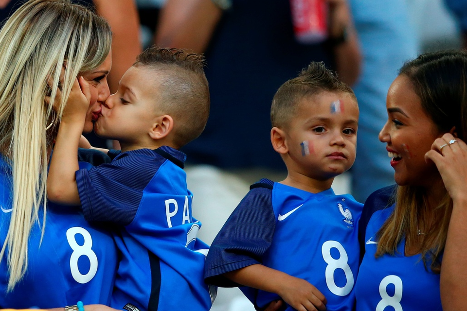 The beautiful game - football fans from around the world -  Ludivine Payet (1st L), wife of Dimitri Payet of France kisses her child prior to the match between Germany and France at Stade Velodrome on July 7, 2016 in Marseille, France.