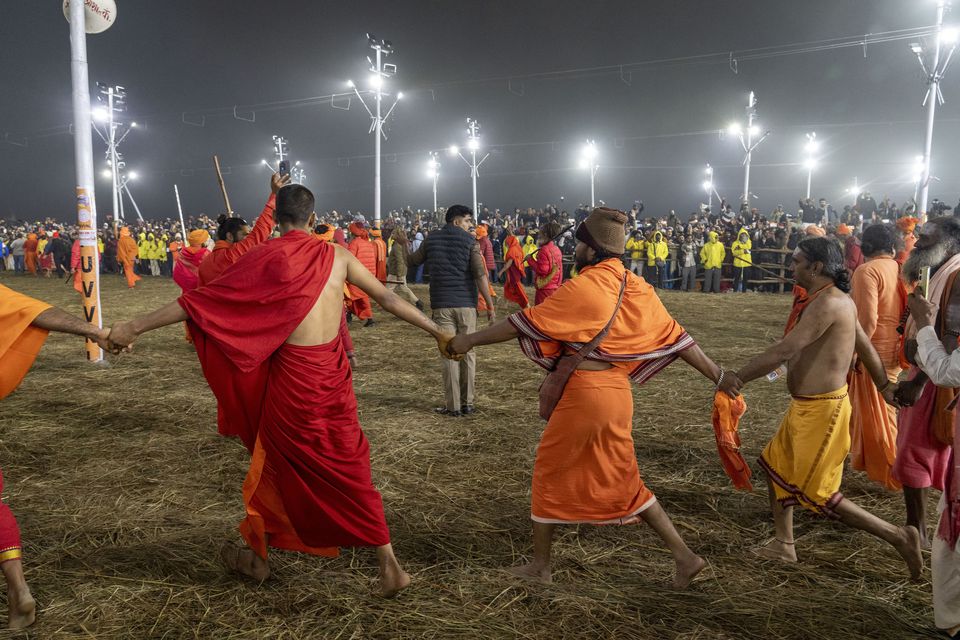 Followers line the path as Hindu holy men walk in procession to bathe at the confluence of the Ganges, the Yamuna and the mythical Saraswati rivers (Ashwini Bhatia/AP)