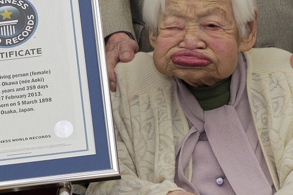 The world's oldest woman - 114-year-old Misao Okawa, from Japan - poses with her certificate from Guinness World Records (AP)