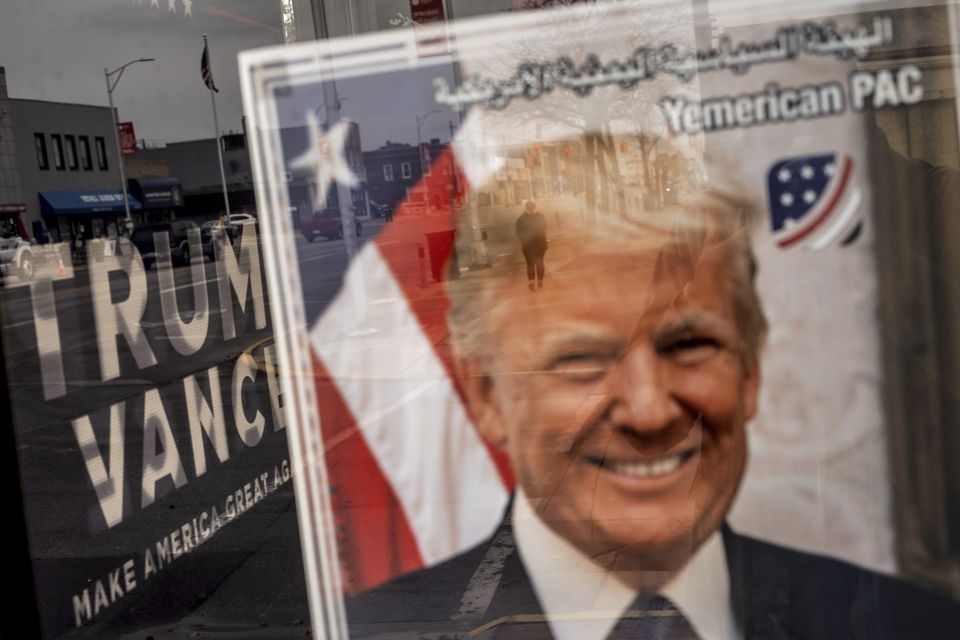 An image of Republican presidential nominee Donald Trump hangs in the window of a campaign office in Hamtramck, Michigan (David Goldman/AP)