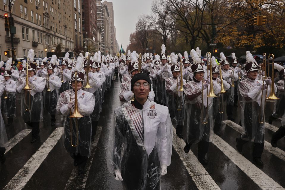 The University of Massachusetts Minutemen marching band marches down Central Park West (Yuki Iwamura/AP)