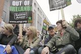 thumbnail: Protestors make their way down a street in Dublin after the Queen arrived in the country for a four day state visit.