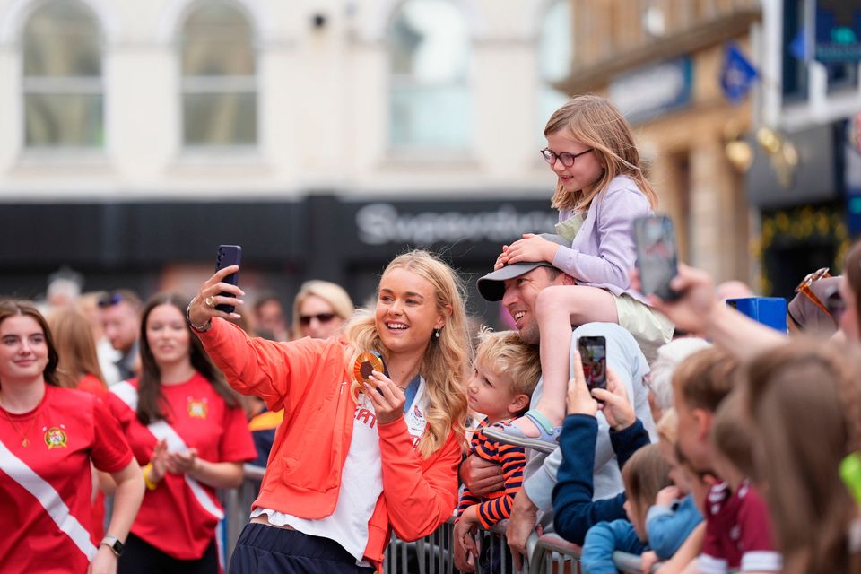 Hannah snapping a selfie during her homecoming parade. Pic: Niall Carson/PA