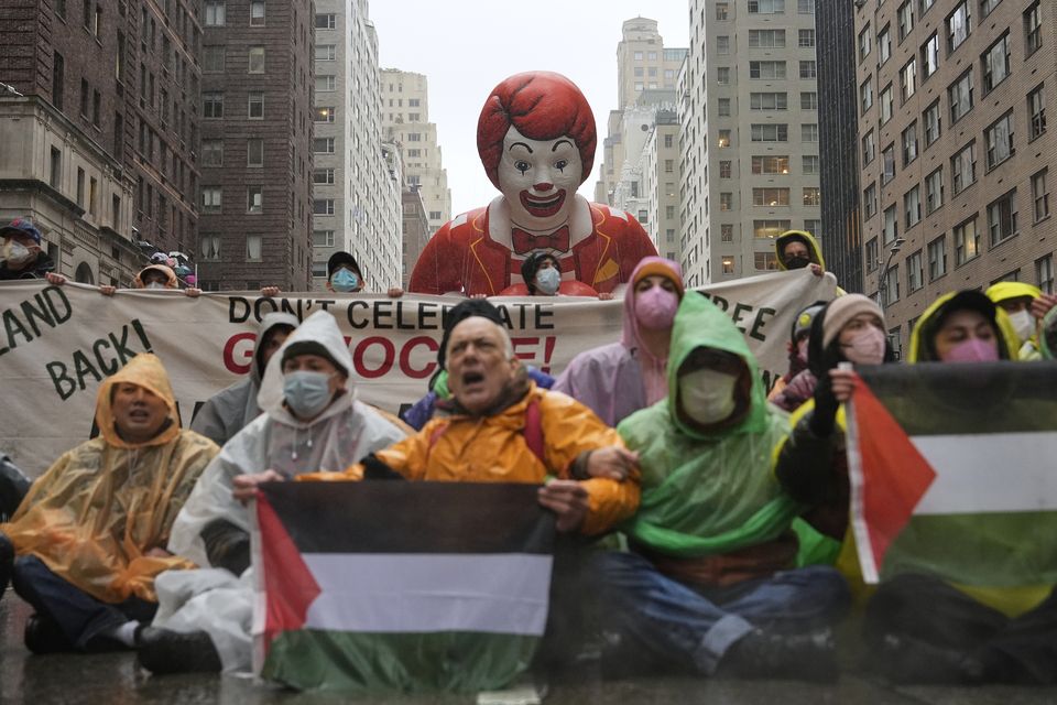 Pro-Palestinian protesters demonstrate on Sixth Avenue during the parade (Julia Demaree Nikhinson/AP)