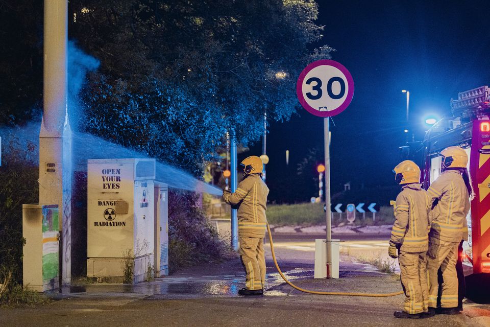 Firefighters deal with an arson at a 5G mast on the Monagh Bypass in west Belfast on July 31st 2024 (Photo by Kevin Scott)
