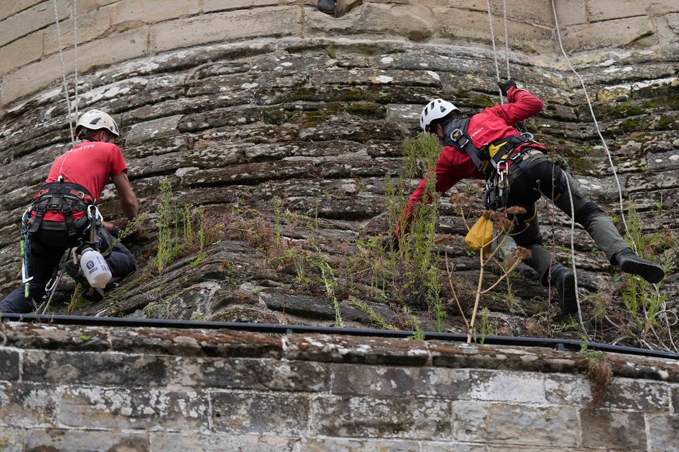 Weeds have sprouted on the stone walls of Warwick Castle’s south front since its last clean-up (Jacob King/PA)