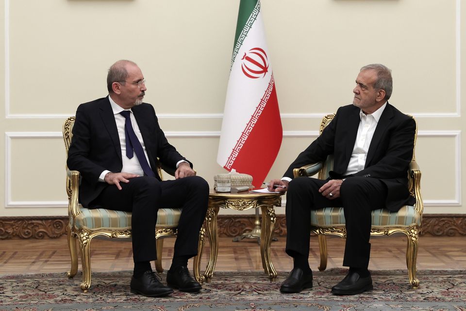 In this photo released by the Iranian Presidency Office, President Masoud Pezeshkian, right, meets Jordan’s Foreign Minister Ayman Safadi, at his office in Tehran (Iranian Presidency Office/AP)