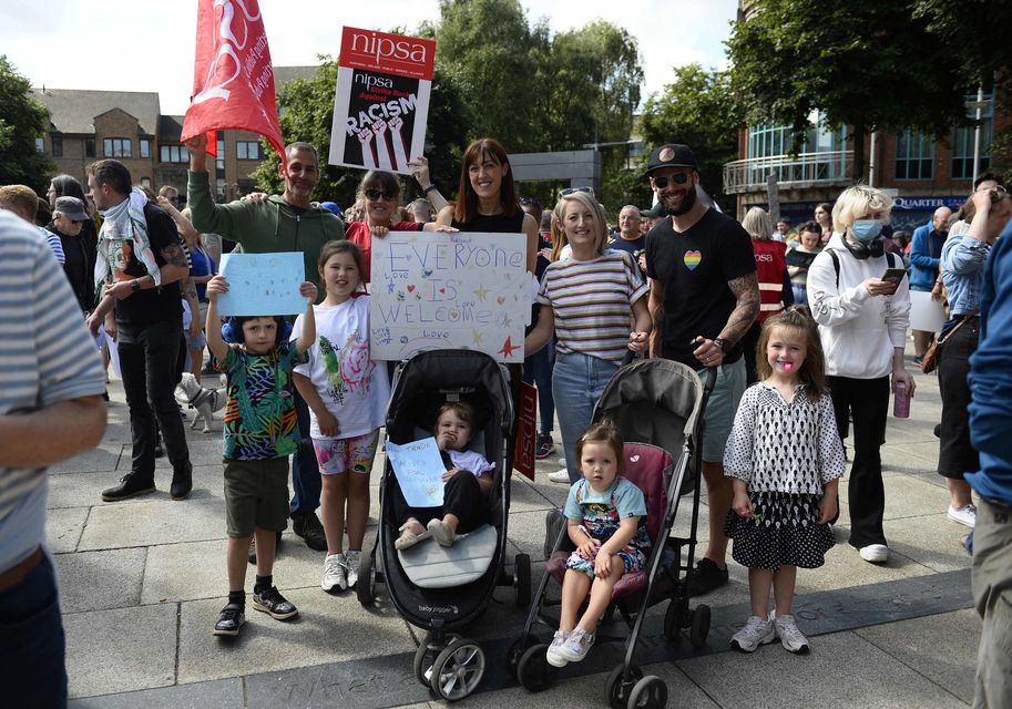 Demonstrators take part in a United Against Racism rally in Belfast on Saturday (PA)