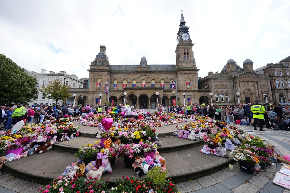 Flowers and tributes outside the Atkinson Art Centre in Southport (Owen Humphreys/PA)