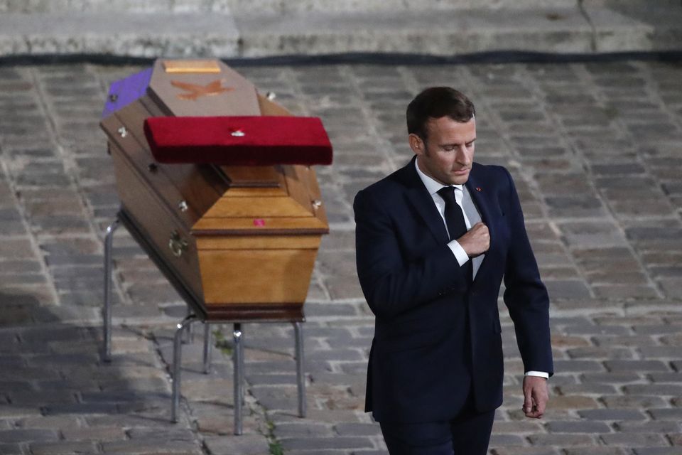 French President Emmanuel Macron leaves after paying his respects by the coffin of teacher Samuel Paty during a national memorial event in 2020 in Paris (Francois Mori/AP)