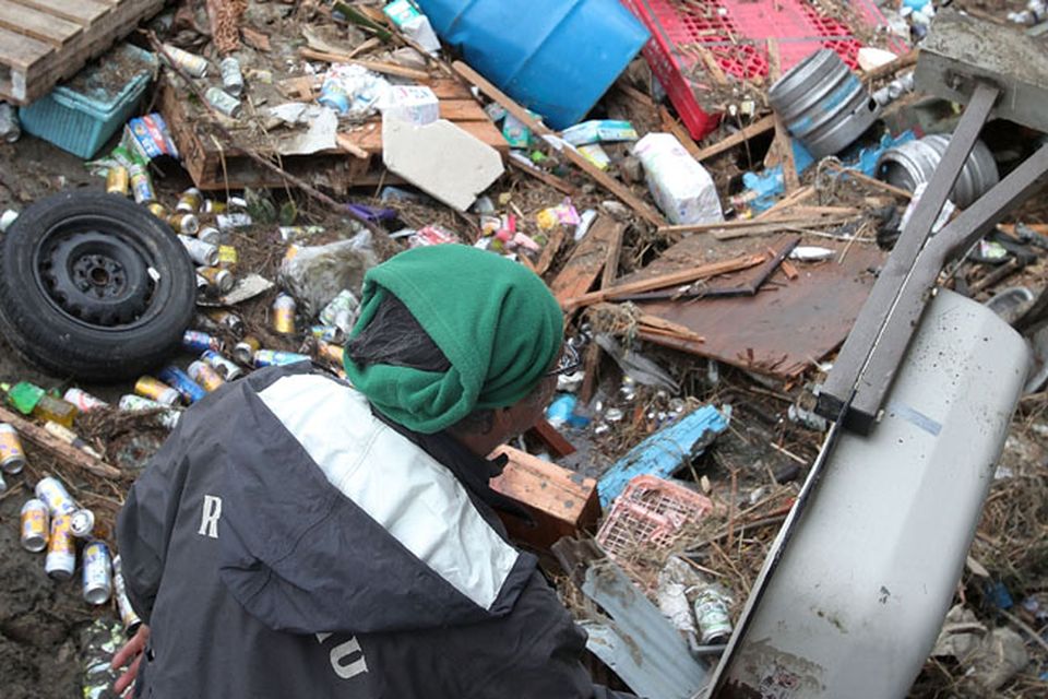 A local resident clears up in the area damaged by tsunami after a 9.0 magnitude strong earthquake struck on March 11 off the coast of north-eastern Japan, on March 15, 2011 in Sendai, Japan. The quake struck offshore at 2:46pm local time, triggering a tsunami wave of up to 10 metres which engulfed large parts of north-eastern Japan. The death toll continues to rise with fears that the official death count could well reach up to 10,000 in "the most tragic event in Japanese history since World War Two".