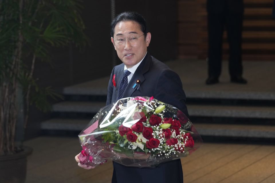 Mr Kishida was presented with a bouquet of red roses and applauded by his staff and former Cabinet members after a brief send-off ceremony (Hiro Komae/AP)