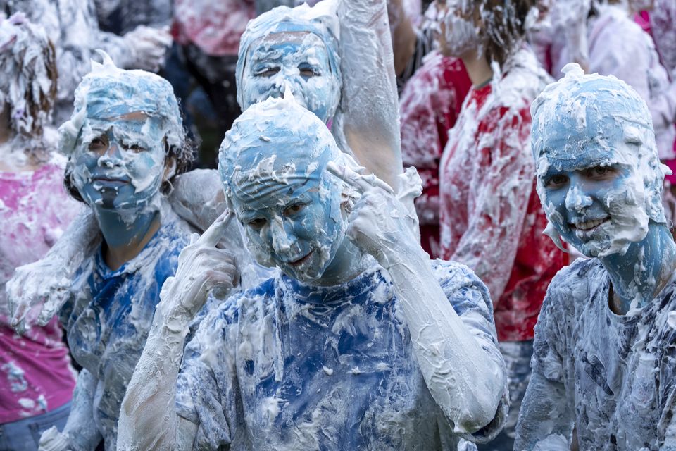 Applying colourful makeup before the foaming begins is part of the fun (Jane Barlow/PA)