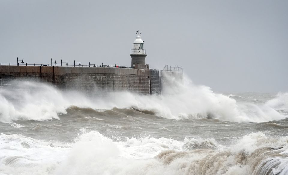 Waves crash against the harbour wall during wet and windy weather in Folkestone (Gareth Fuller/PA)