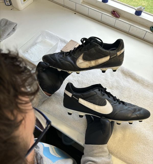 Daniel restoring a pair of football boots