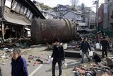 thumbnail: People walk to receive water supply through a street with the rubble Monday March 14, 2011 in Kesennuma, Miyagi Prefecture, northern Japan  following Friday's massive earthquake and the ensuing tsunami. (AP Photo/Kyodo News) JAPAN OUT, MANDATORY CREDIT, NO SALES IN CHINA, HONG  KONG, JAPAN, SOUTH KOREA AND FRANCE