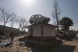 thumbnail: A car sits on top of a small building in a destroyed neighborhood in Sendai, Japan, on Sunday, March 13, 2011 after it was washed into the area by the tsunami that hit northeastern Japan. AP Photo/David Guttenfelder)