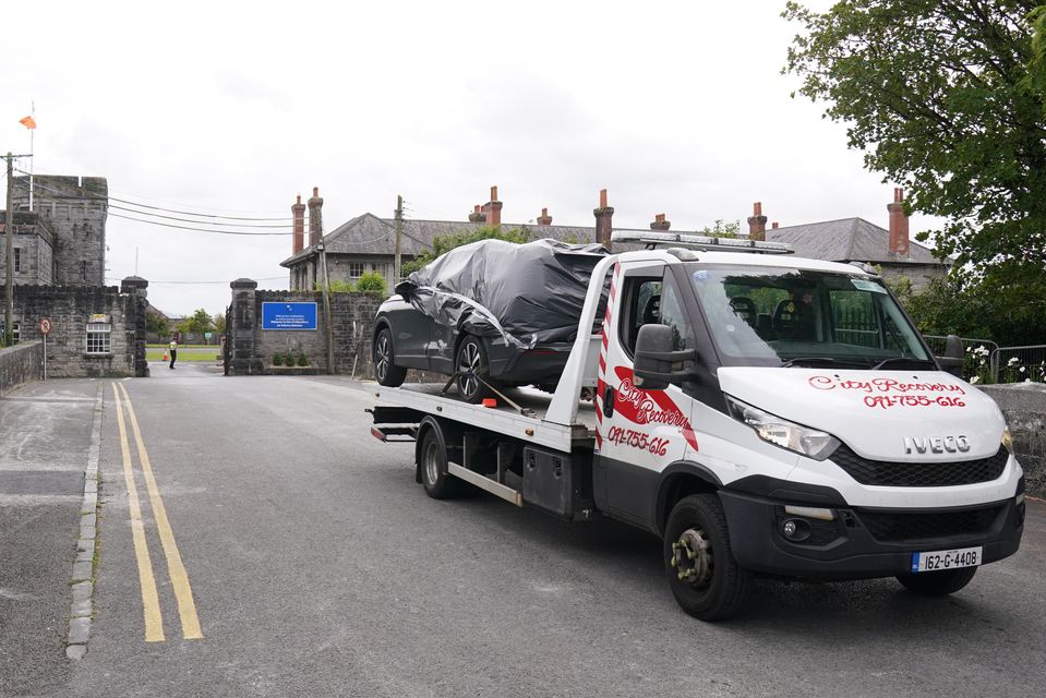 A car being removed from the scene (Brian Lawless/PA)