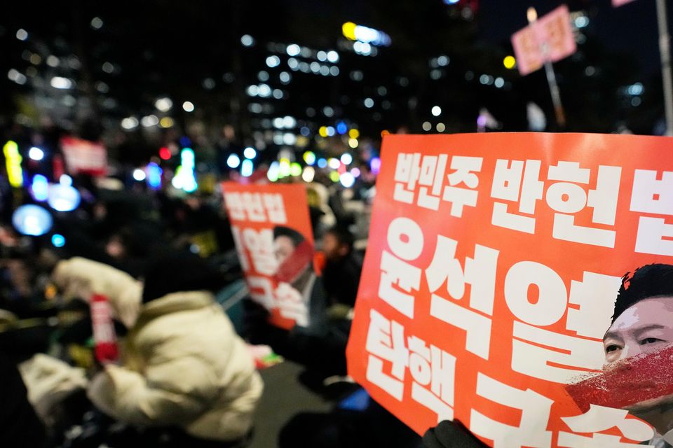 Participants hold banners during a rally to demand South Korean President Yoon Suk Yeol’s impeachment (Ahn Young-Joon/AP)