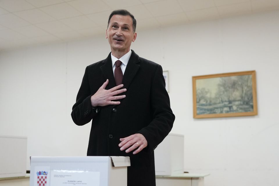 Croatian Democratic Union candidate Dragan Primorac casts his vote at a polling station in Zagreb (Darko Bandic/AP)