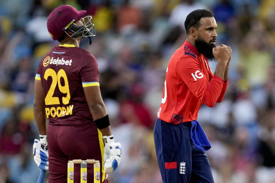 England’s Adil Rashid celebrates taking the wicket of West Indies’ captain Rovman Powell (Ricardo Mazalan/AP)