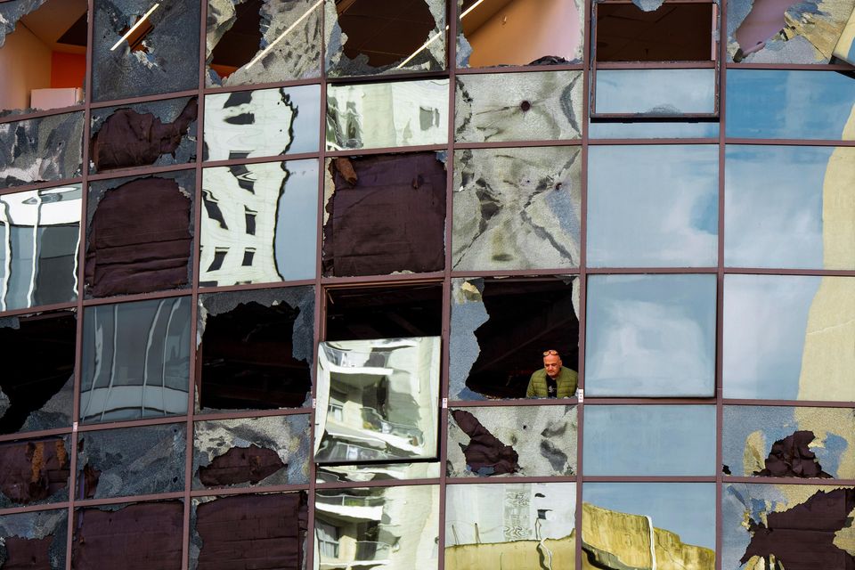 A man looks from a damaged building a day after it was hit by a rocket fired from Lebanon, in Ramat Gan, central Israel (Oded Balilty/AP)