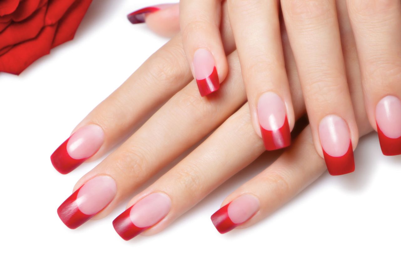 Female Hand With Nails Covered With Red Lacquer Pulls Down The