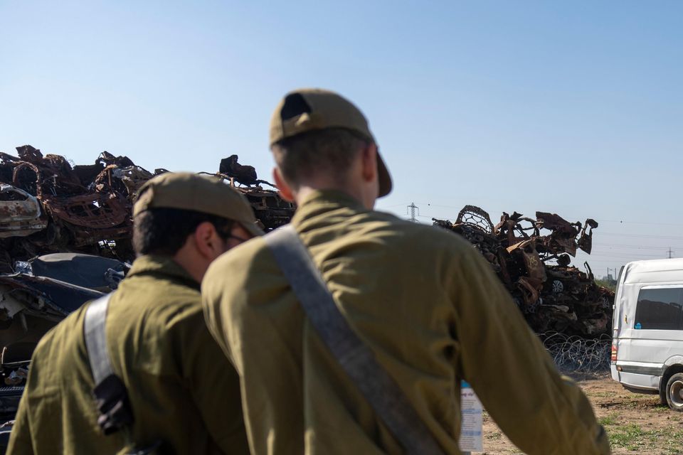 Israeli soldiers look at destroyed motorcycles outside the town of Netivot in southern Israel (Ariel Schalit/AP)