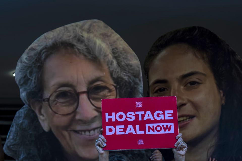 Relatives and supporters of Israeli hostages held by Hamas in Gaza hold photos of their loved ones during a protest calling for their return in Tel Aviv (Ariel Schalit/AP/PA)