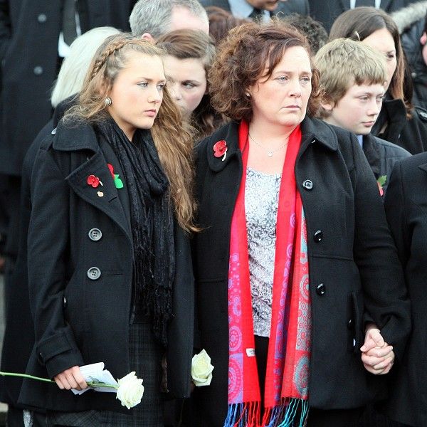 Yvonne Black, wife of murdered prison officer David Black, with her daughter Kyra after his funeral service in Co Tyrone
