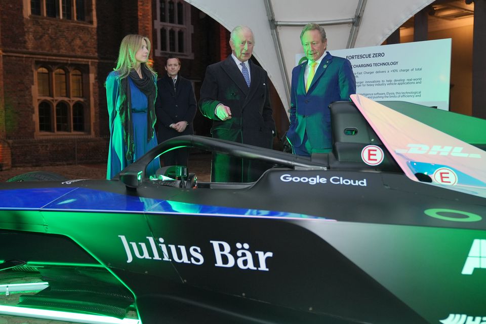 Charles looking at a Formula E car with SMI chief executive Jennifer Jordan-Saifi (left) and Dr Andrew Forrest executive chairman and founder of Fortescu (right) (Yui Mok/PA)