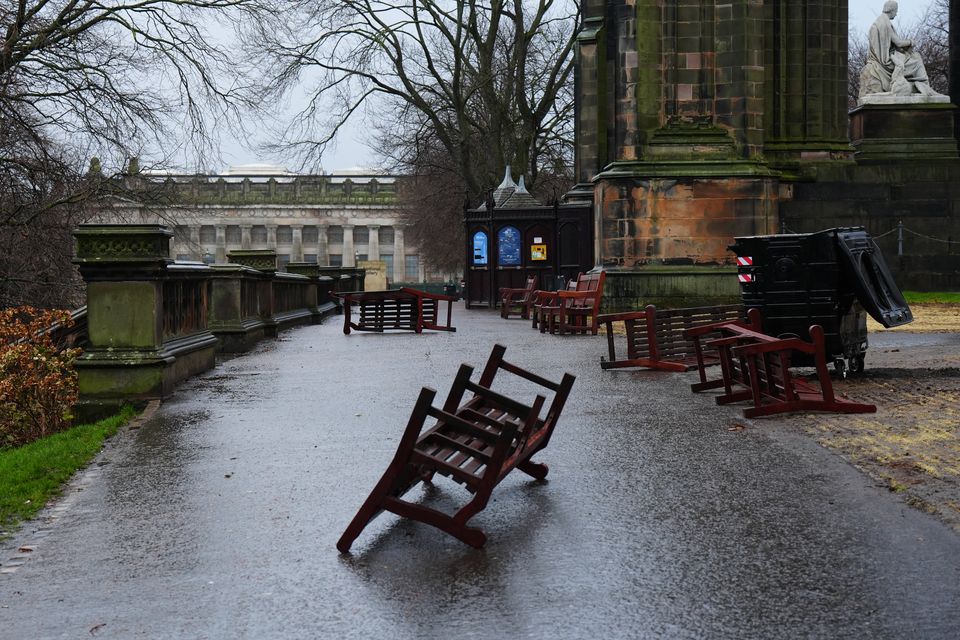 Wooden park benches blown over by the winds from Storm Eowyn in Princes Street Gardens, Edinburgh (Jane Barlow/PA)