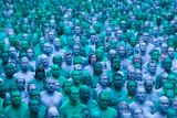 thumbnail: Naked volunteers, painted in blue to reflect the colours found in Marine paintings in Hull's Ferens Art Gallery, participate in US artist, Spencer Tunick's "Sea of Hull" installation in Kingston upon Hull on July 9, 2016. AFP/Getty Images