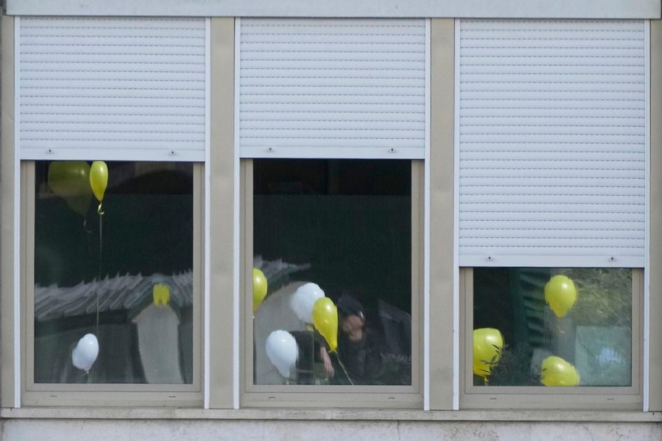 Balloons with the colours of the Vatican flag are reflected on the windows of the Gemelli hospital (Gregorio Borgia/AP)