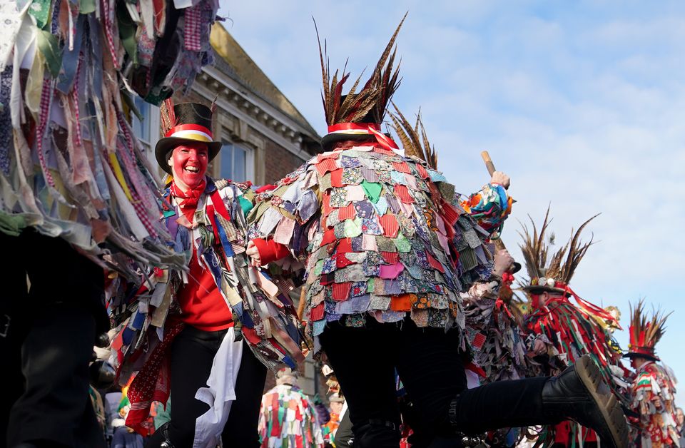 Morris dancers perform in the streets of Whittlesea, Cambridgeshire while wearing colourful attire (Joe Giddens/PA)