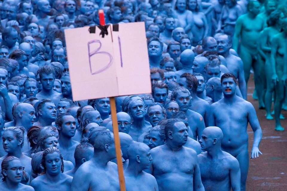 Naked volunteers, painted in blue to reflect the colours found in Marine paintings in Hull's Ferens Art Gallery, prepare to participate in US artist, Spencer Tunick's "Sea of Hull" installation on the Scale Lane swing bridge in Kingston upon Hull on July 9, 2016. AFP/Getty Images