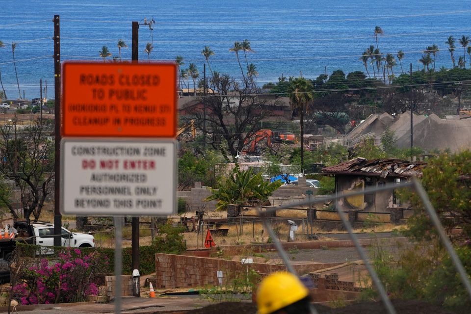 Crews work to clean debris and repave roads, on Saturday, July 6, 2024, in Lahaina, Hawaii (Lindsey Wasson/AP)