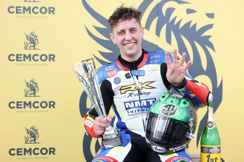 English road racer Dominic Herbertson celebrates his quadruple at the Cookstown 100