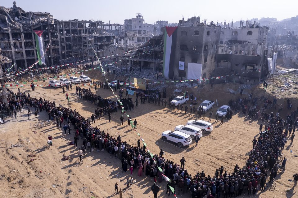 Red Cross vehicles, left, wait for the hand-over of Israeli soldier hostage Agam Berger at the Jabalya refugee camp in Gaza City (AP Photo/Mohammad Abu Samra)