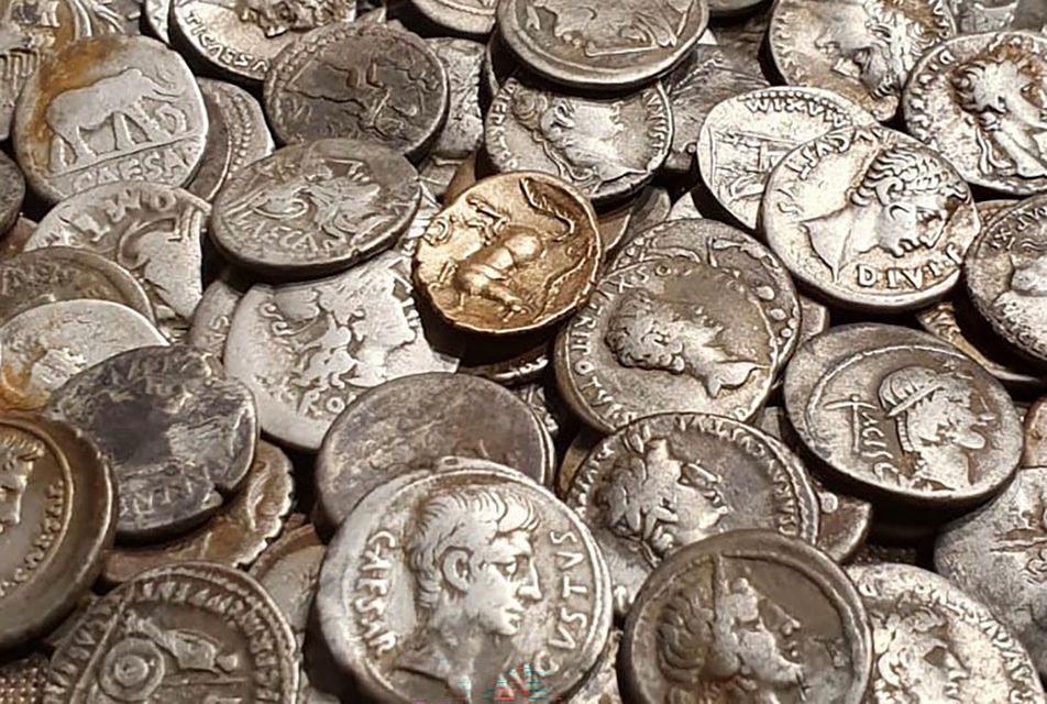 Coins discovered by metal detectorist George Ridgway, who was inspired by Indiana Jones, have sold at auction for £132,865 (George Ridgway/PA)